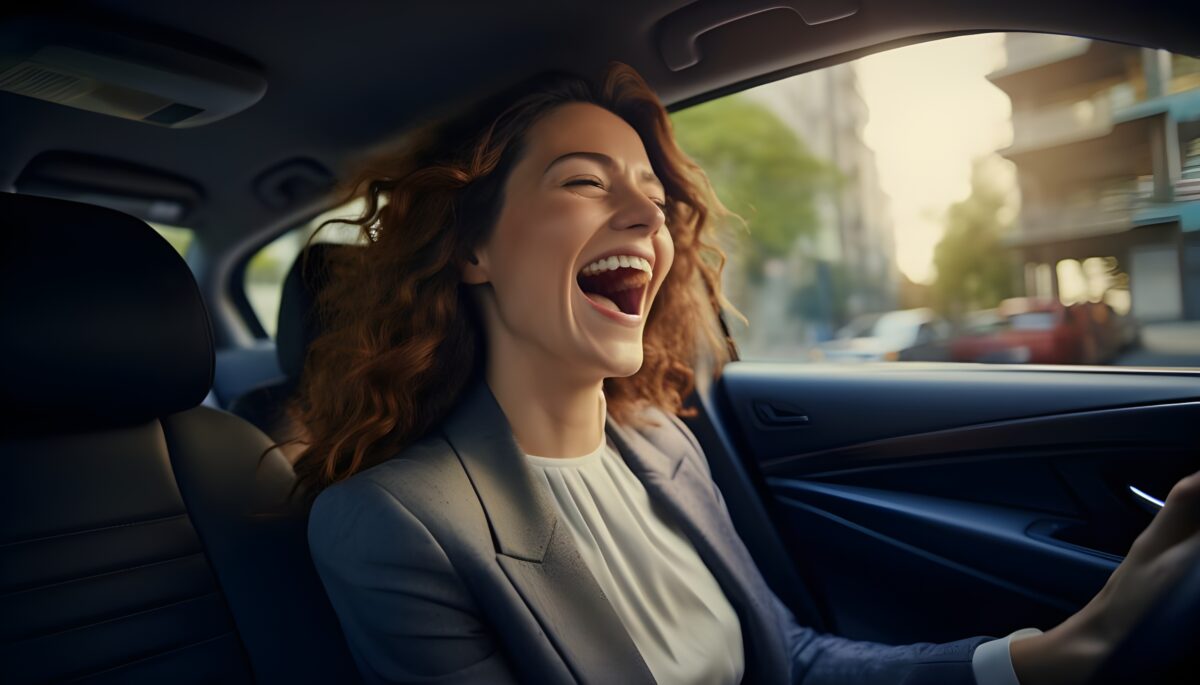 young business woman singing in car